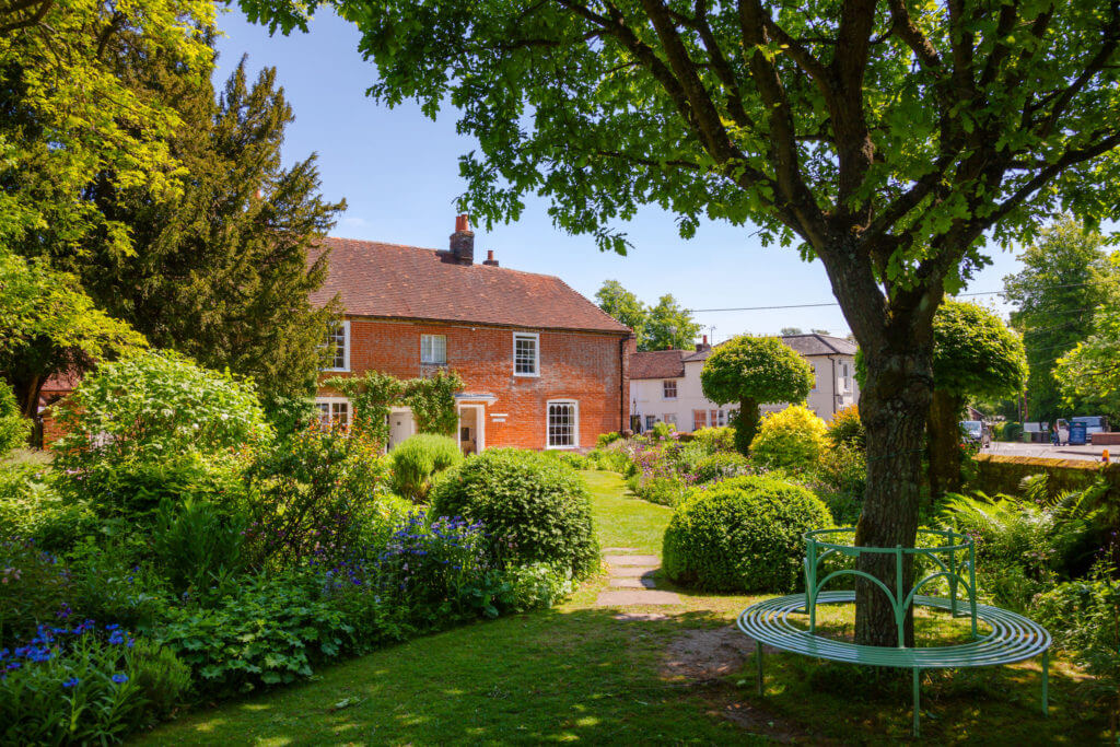 Round bench at formal garden of Chawton Cottage, an independent museum of novelist Jane Austen