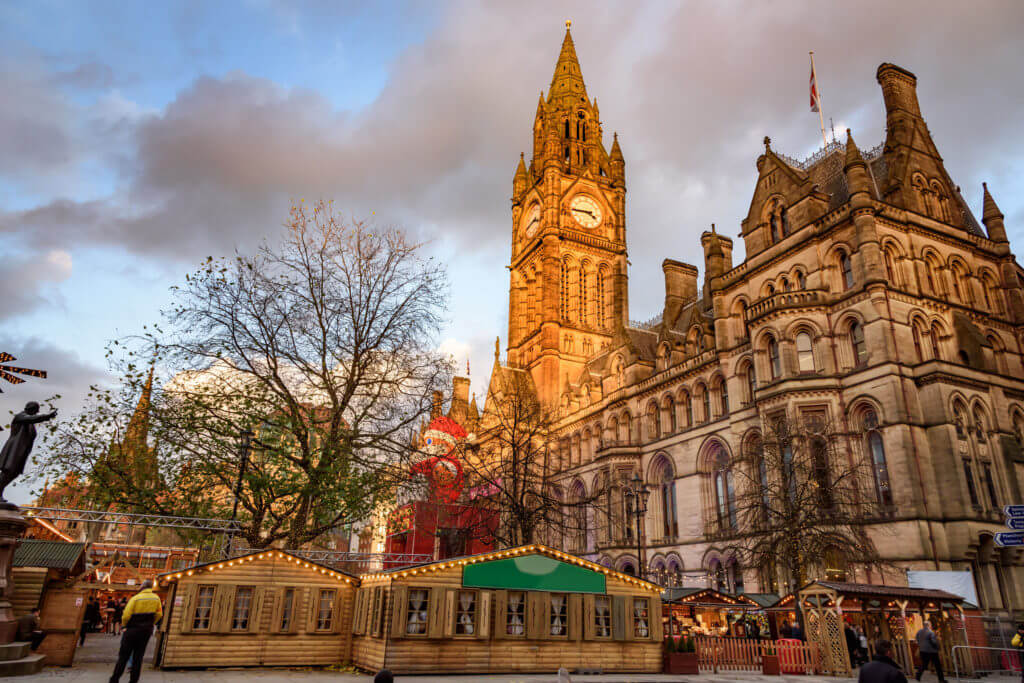 Manchester town hall and father christmas at christmas market Albert Square, Manchester, England.