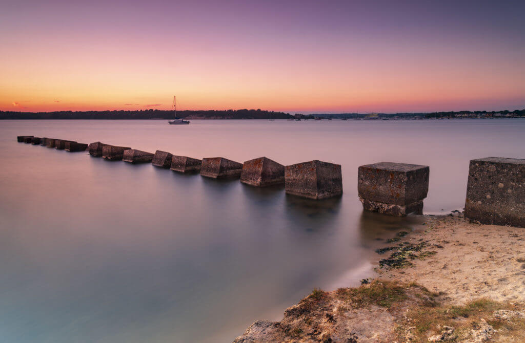 Sunset over Dragon's Teeth wartime sea defences in Poole Harbour