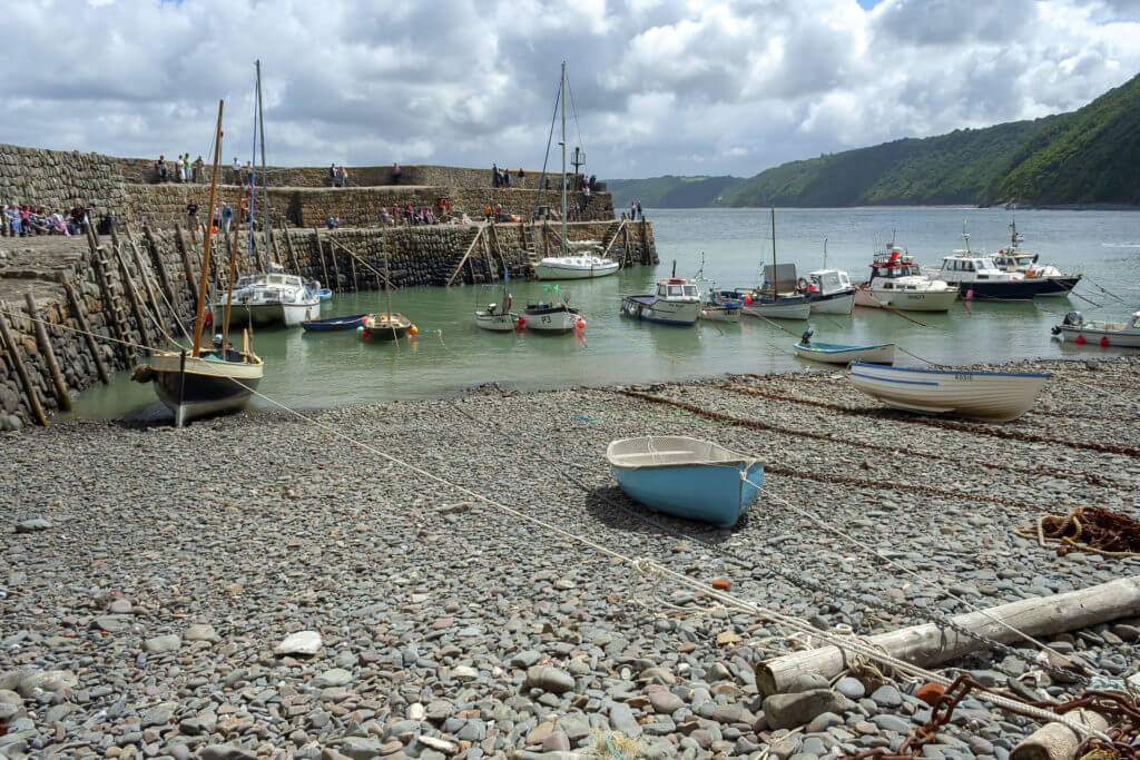 Clovelly, Devon, UK - July 8, 2008: Clovelly harbour with moored boats on a cloudy summer day