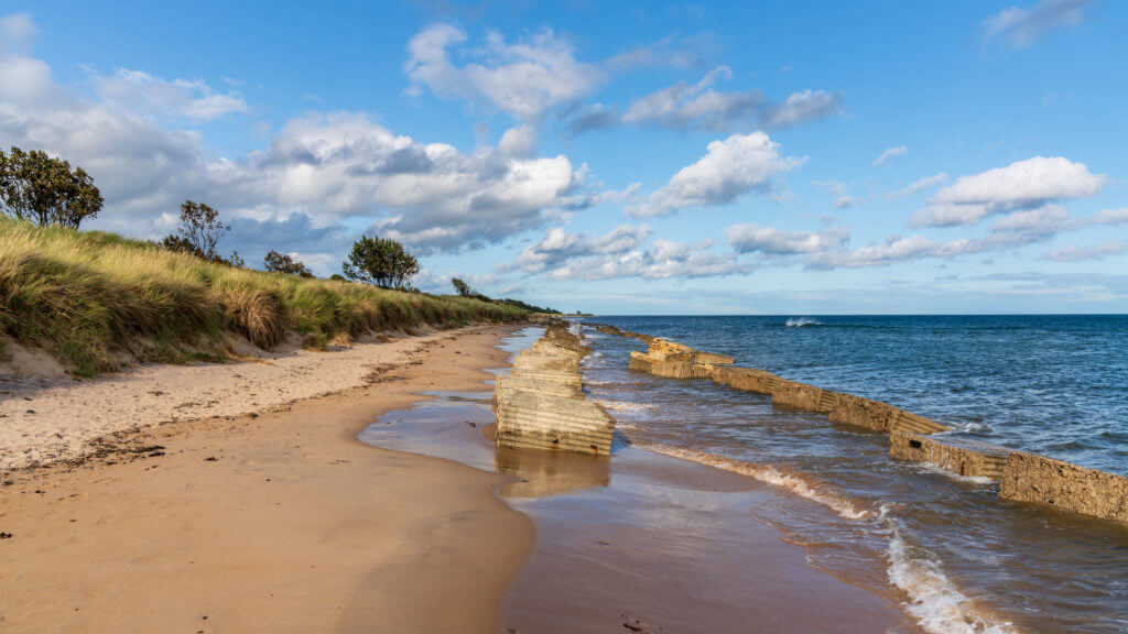 North Sea Coast in Alnmouth in Northumberland, England, UK - with some anti-tank blocks from the second world war on the beach