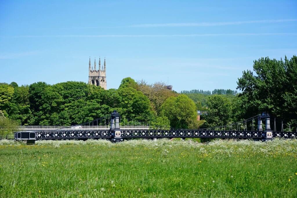 View of the Ferry Bridge also known as the Stapenhill Ferry Bridge with St Peters church tower to the rear and a meadow in the foreground, Burton upon Trent, Staffordshire, England, UK, Western Europe.