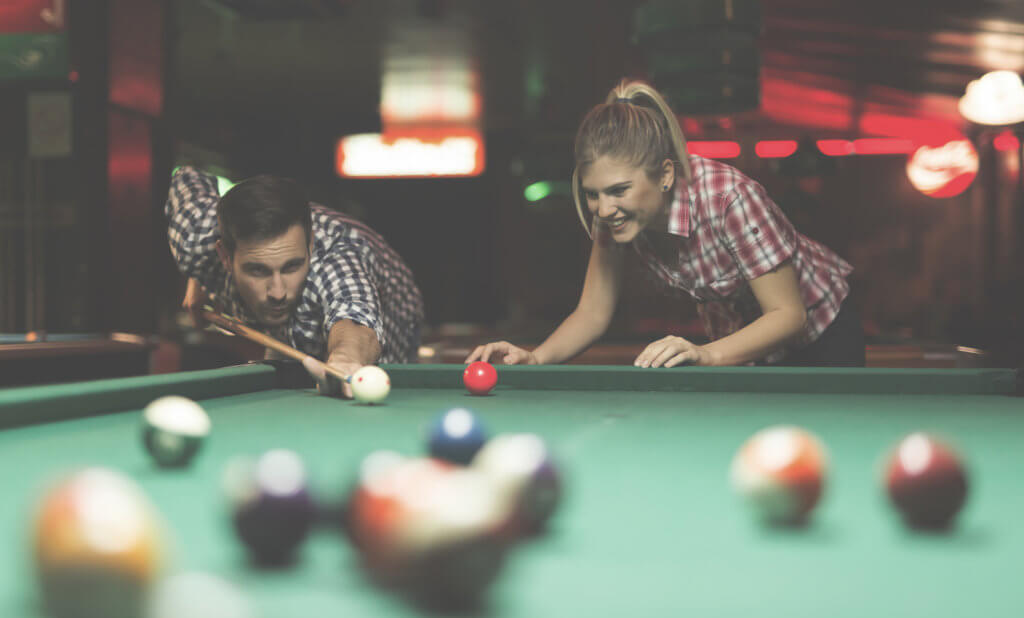 Couple playing snooker together