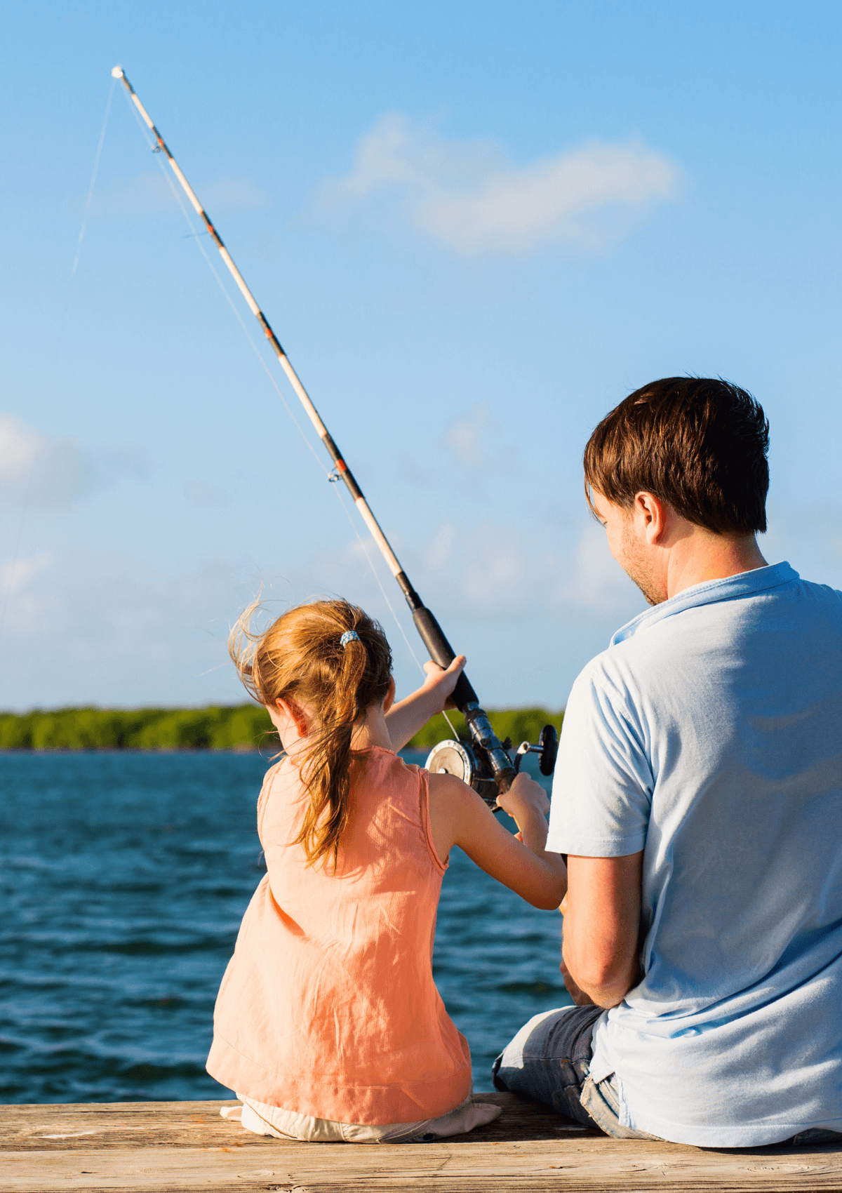 Father and daughter fishing, England 