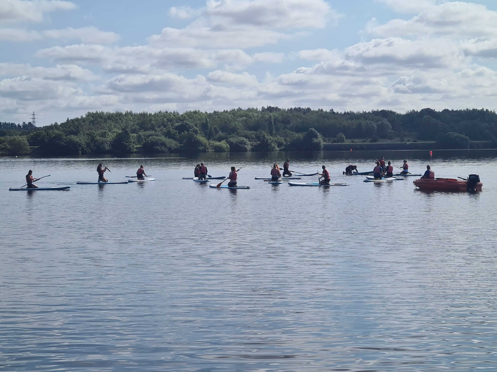 People paddle boarding at Scotman’s Flash, Wigan, England
