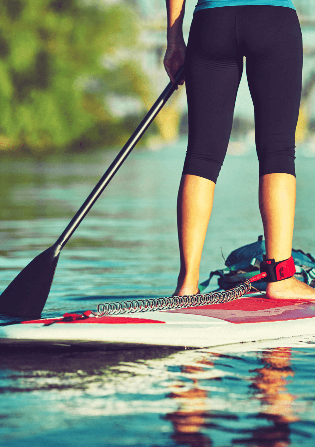 A woman paddleboarding in Merseyside, England