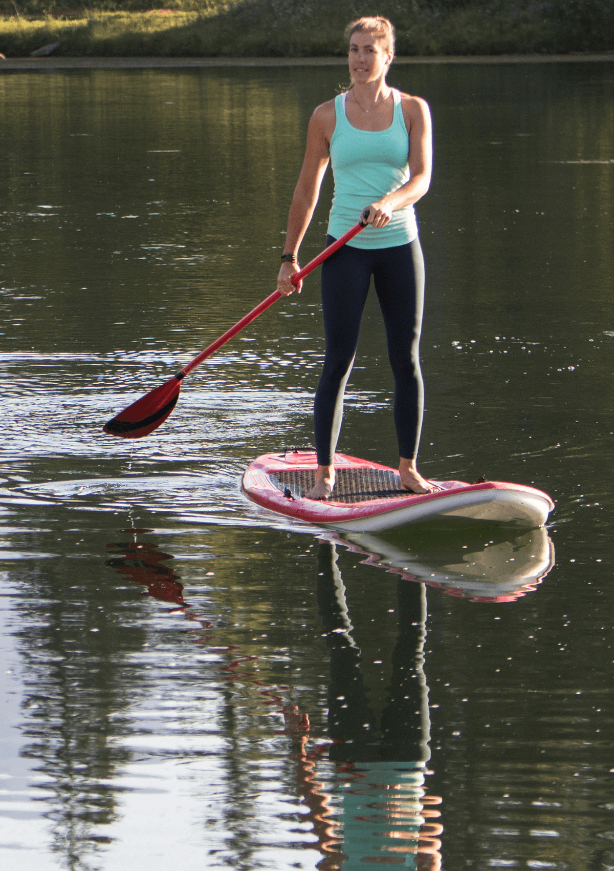 Woman paddleboarding on a river