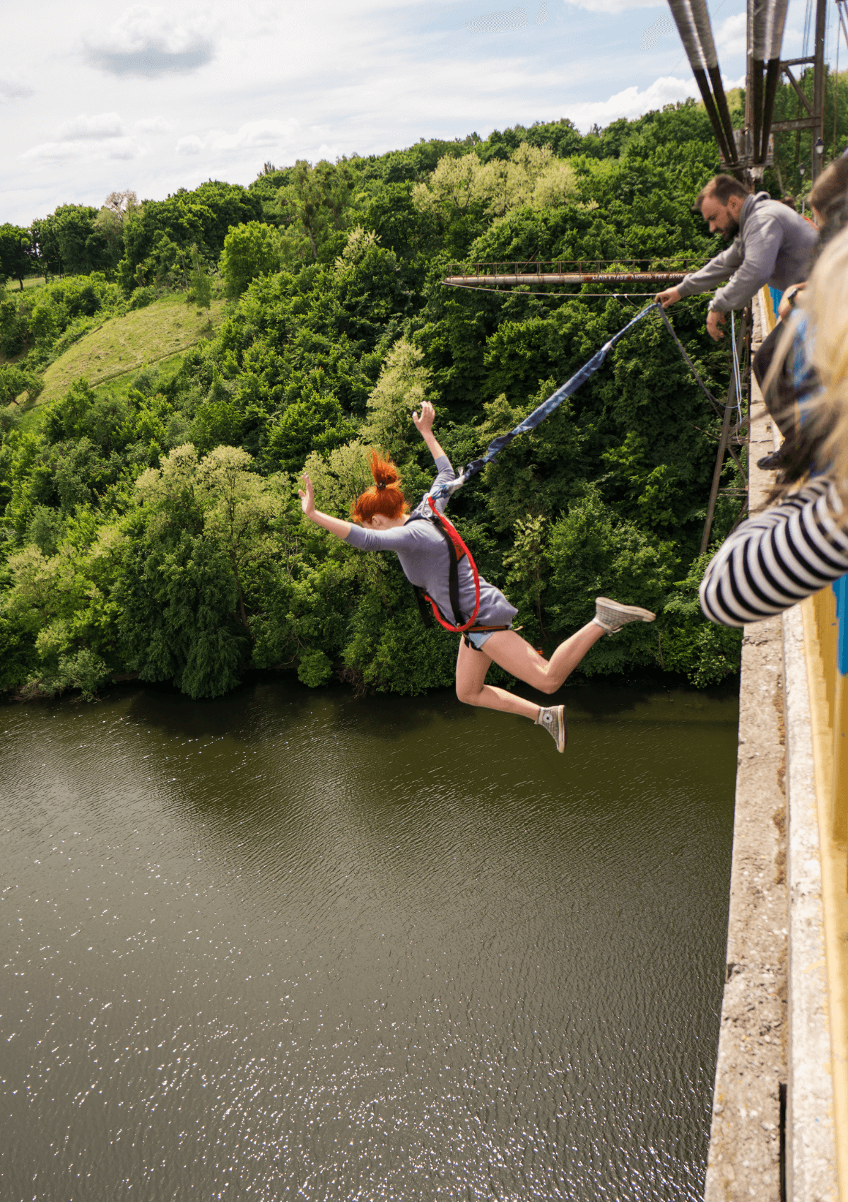Woman bungee jumping from bridge 