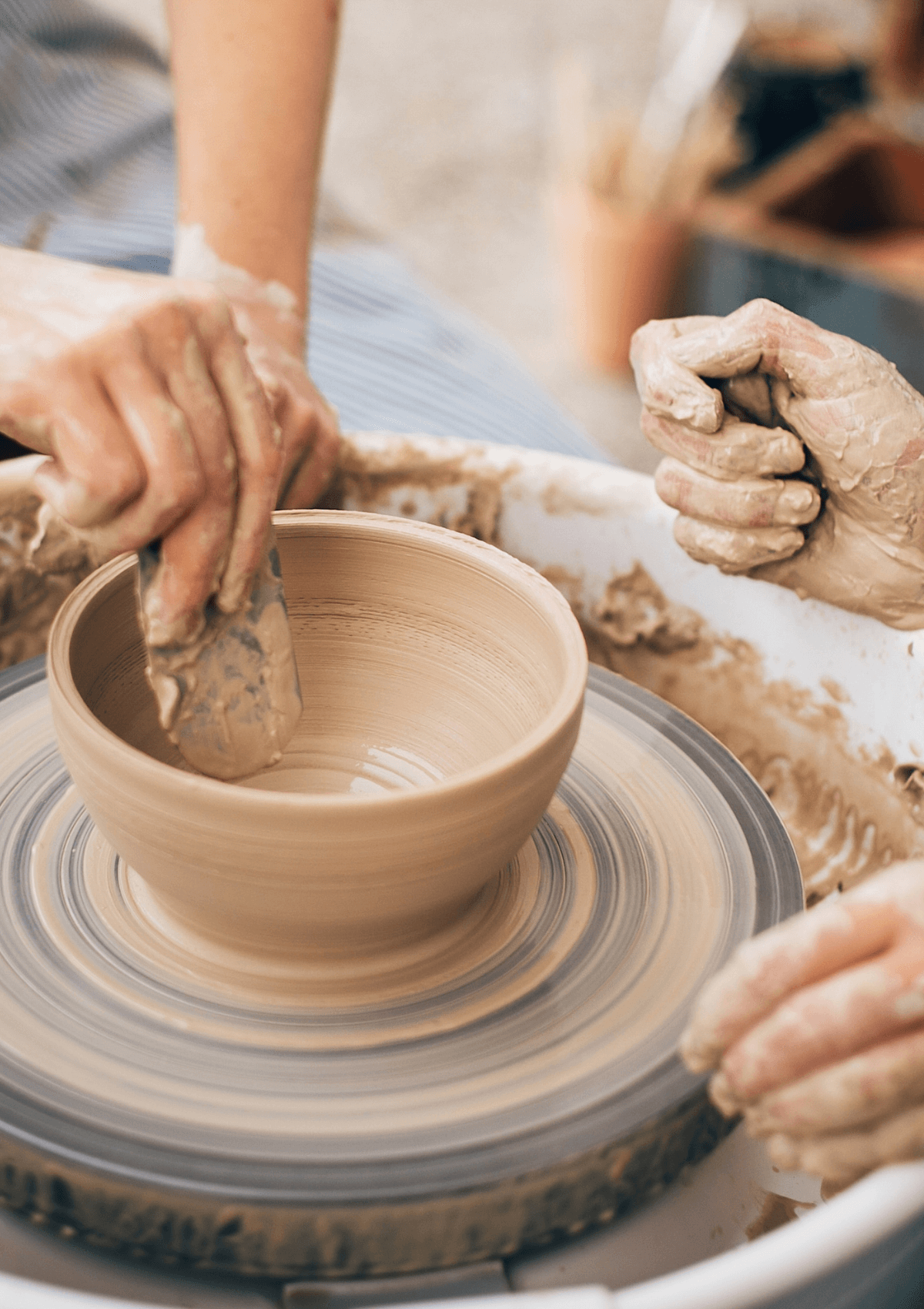 Couple making pottery together 